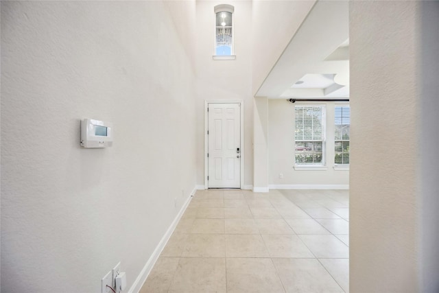 tiled entryway featuring a raised ceiling