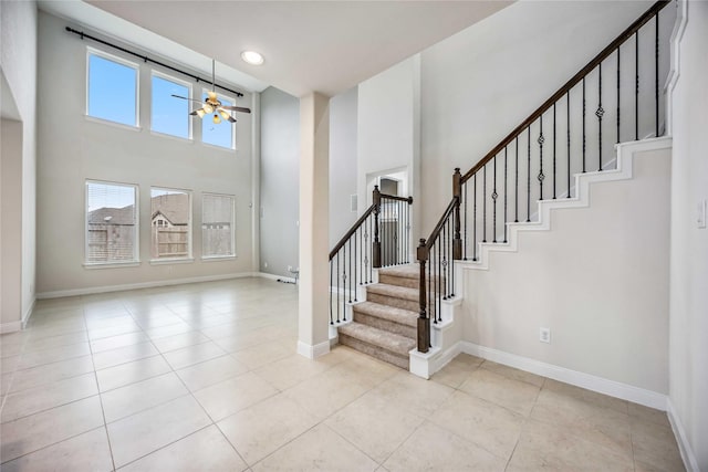 tiled entrance foyer with ceiling fan