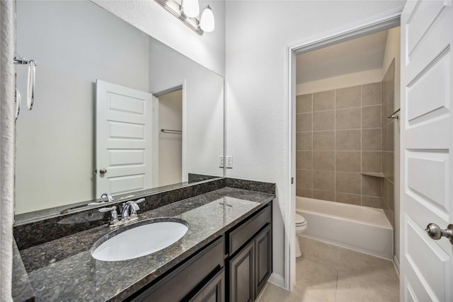 full bathroom with toilet, tile patterned flooring, tiled shower / bath combo, and vanity