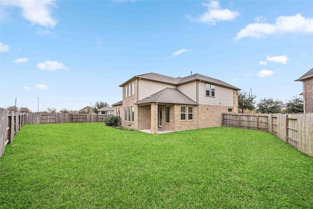 back of house with a yard