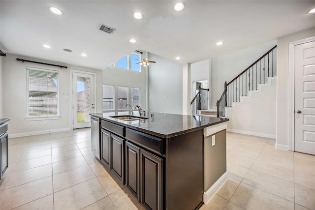 kitchen featuring ceiling fan, dishwasher, a wealth of natural light, sink, and an island with sink