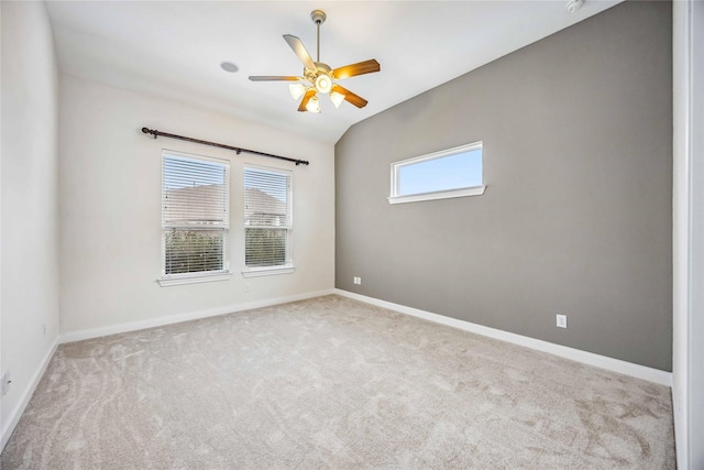 carpeted spare room with lofted ceiling, ceiling fan, and a healthy amount of sunlight