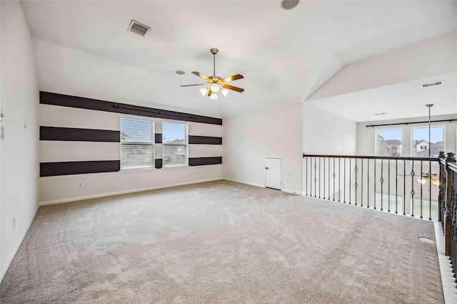 spare room with vaulted ceiling, ceiling fan, and carpet