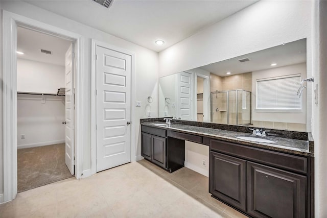 bathroom featuring an enclosed shower, vanity, and tile patterned floors