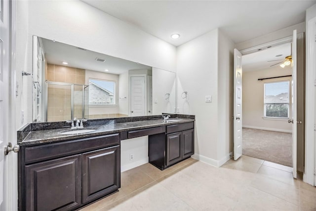 bathroom featuring ceiling fan, tile patterned floors, walk in shower, and vanity