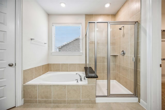 bathroom featuring independent shower and bath