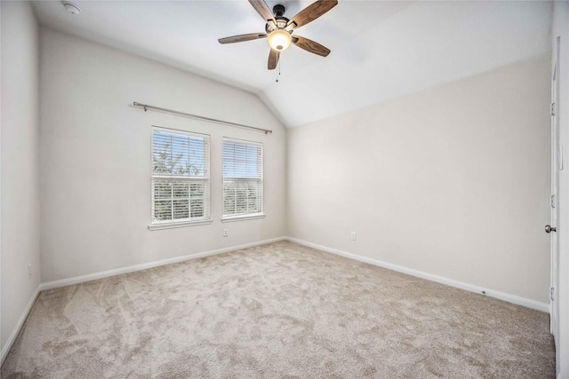 carpeted spare room featuring lofted ceiling and ceiling fan