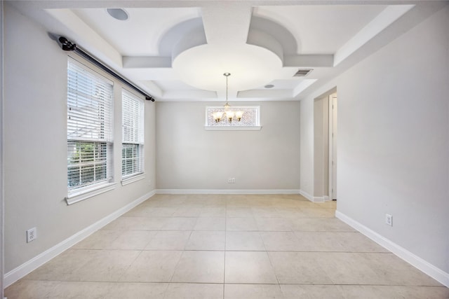 tiled spare room featuring a notable chandelier, a tray ceiling, and coffered ceiling