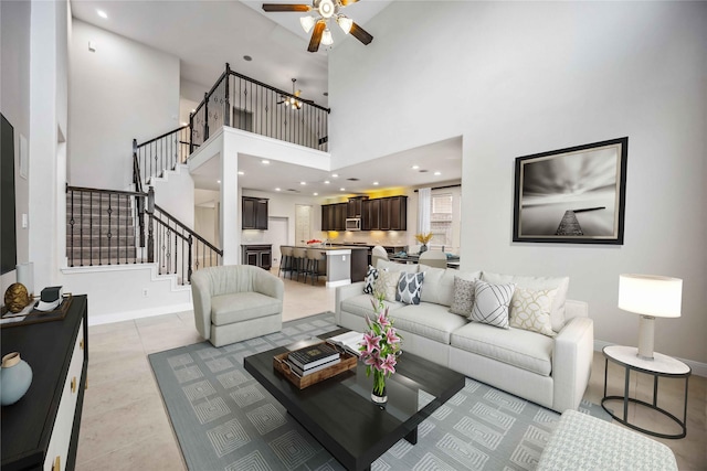 tiled living room with ceiling fan and a towering ceiling