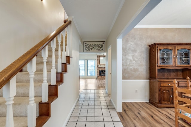 corridor featuring light hardwood / wood-style floors and crown molding