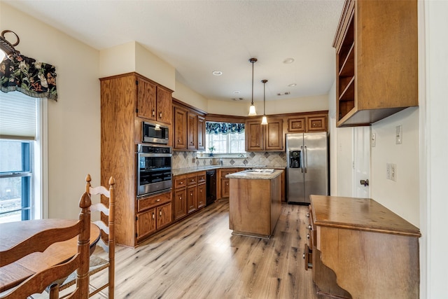 12135 Oakcroft Dr, Houston, TX 77070 - kitchen with light wood finished floors, decorative backsplash, brown cabinetry, a kitchen island, and appliances with stainless steel finishes