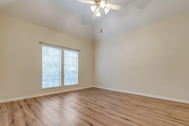 empty room featuring ceiling fan, light wood-type flooring, and high vaulted ceiling