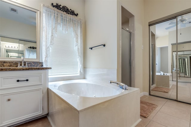 12135 Oakcroft Dr, Houston, TX 77070 - bathroom with a shower stall, a bath, vanity, and tile patterned floors