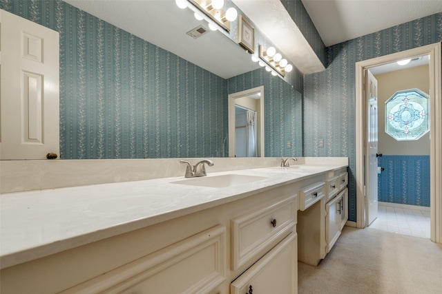12135 Oakcroft Dr, Houston, TX 77070 - full bathroom featuring visible vents, a sink, wallpapered walls, and double vanity