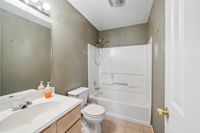 full bathroom featuring washtub / shower combination, tile patterned floors, toilet, a textured ceiling, and vanity