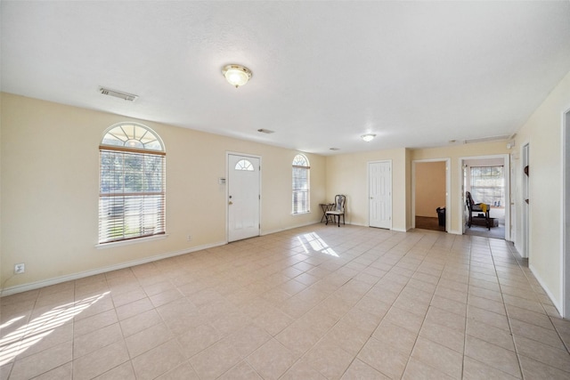 foyer entrance with light tile patterned floors