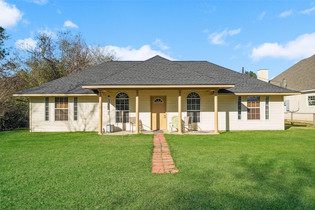 back of property featuring a patio area and a lawn