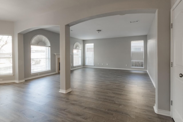 unfurnished room featuring dark wood-type flooring