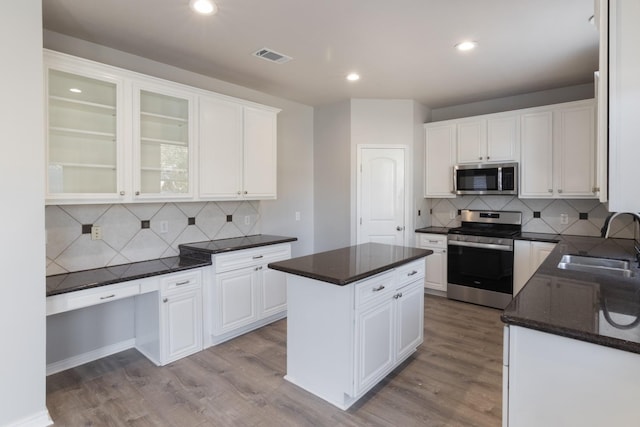 kitchen featuring sink, white cabinets, a center island, light hardwood / wood-style floors, and stainless steel appliances