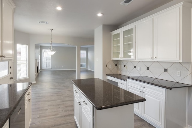 kitchen featuring white cabinetry and dark stone counters