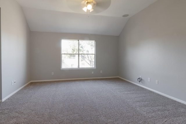 spare room with vaulted ceiling, carpet floors, and ceiling fan