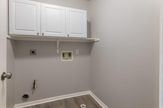 laundry room featuring gas dryer hookup, dark hardwood / wood-style floors, cabinets, washer hookup, and hookup for an electric dryer