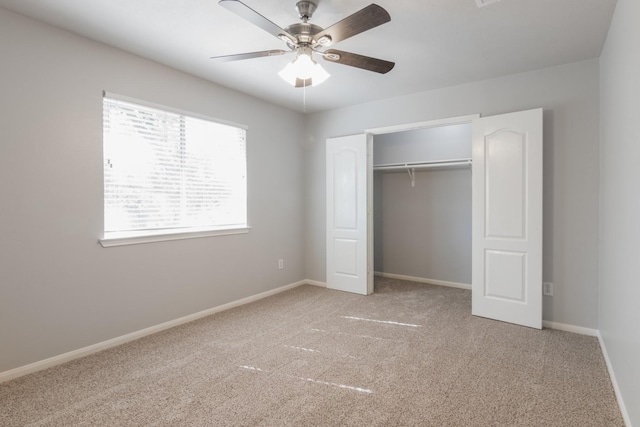 unfurnished bedroom featuring light carpet, a closet, and ceiling fan