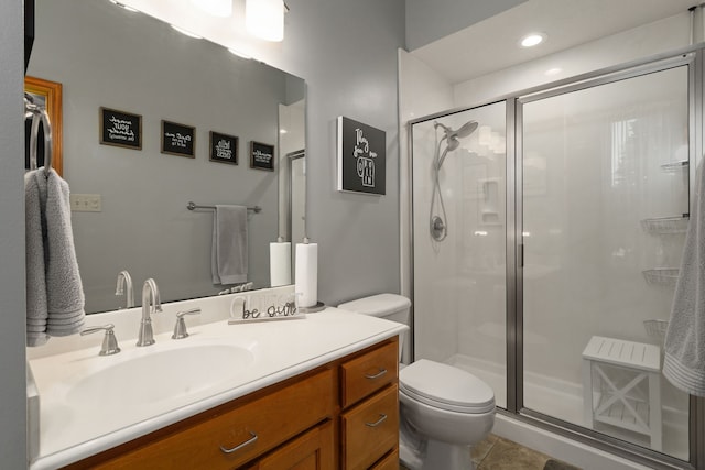 bathroom with tile patterned floors, vanity, toilet, and an enclosed shower