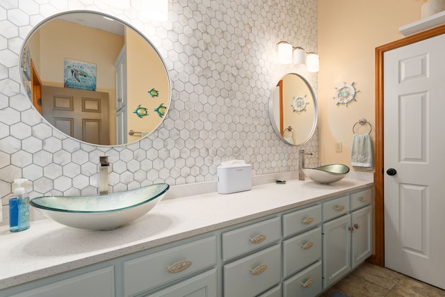 bathroom with tasteful backsplash, tile patterned floors, and vanity