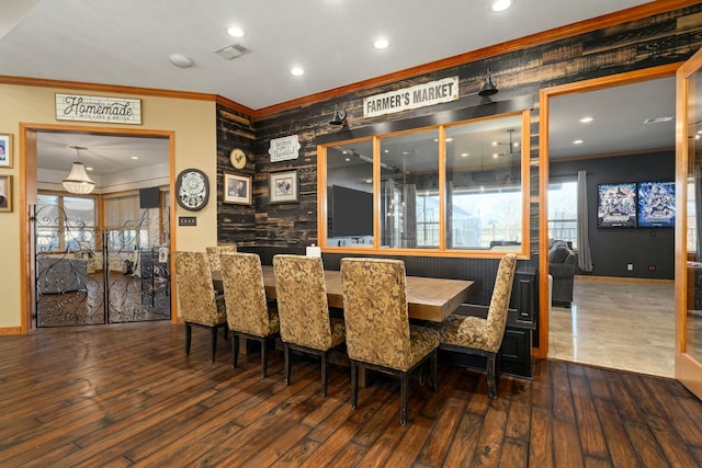 dining room with dark hardwood / wood-style flooring and ornamental molding