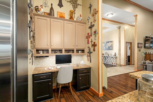 home office featuring dark hardwood / wood-style flooring, built in desk, ornamental molding, and ornate columns