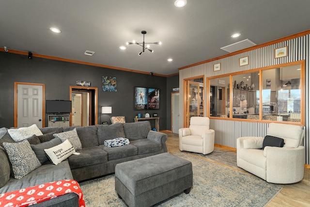 living room featuring a notable chandelier and crown molding