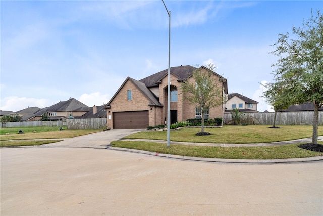 view of front of house featuring a garage and a front lawn