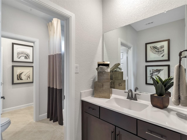 1412 River Point Dr, Friendswood, TX 77546 - bathroom featuring vanity, toilet, tile patterned flooring, a textured wall, and curtained shower