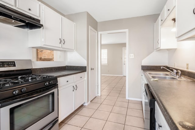 kitchen with dishwasher, stainless steel gas range oven, white cabinets, sink, and light tile patterned floors