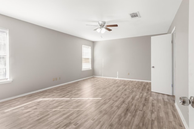 empty room featuring ceiling fan and light hardwood / wood-style floors