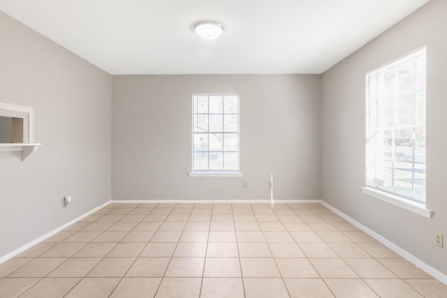 tiled empty room with a healthy amount of sunlight