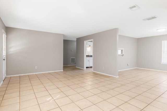 spare room with light tile patterned floors