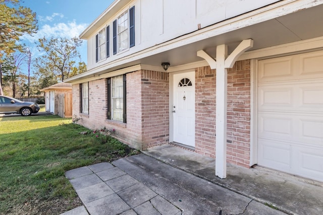 property entrance featuring a lawn and a garage