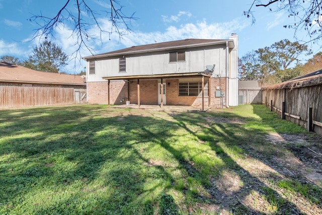 rear view of house featuring a lawn