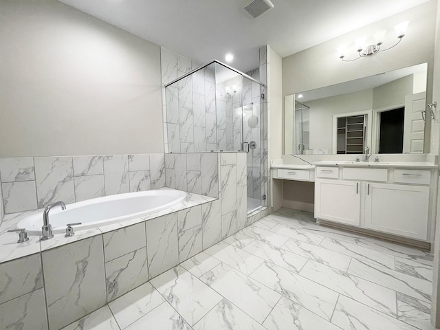 bathroom featuring vanity and shower with separate bathtub