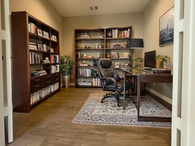 home office with hardwood / wood-style floors