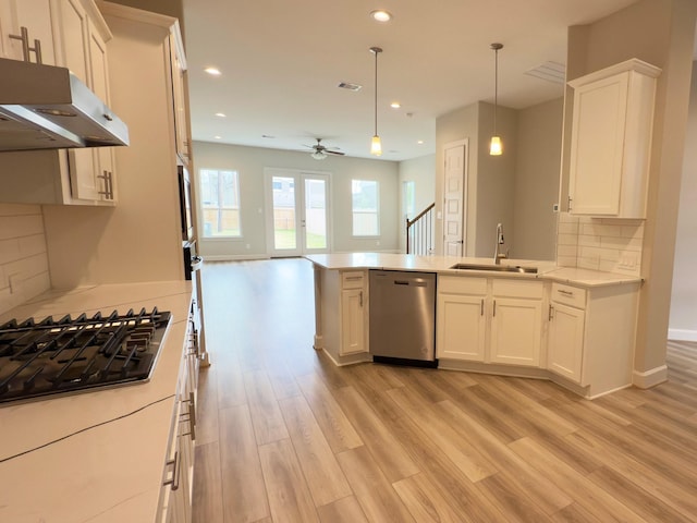 kitchen featuring sink, white cabinetry, dishwasher, pendant lighting, and black gas cooktop