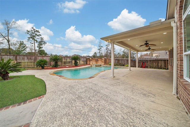 view of pool with a patio, a pool with connected hot tub, a fenced backyard, and a ceiling fan