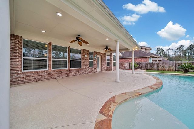 view of swimming pool featuring ceiling fan, a patio, fence, and a fenced in pool