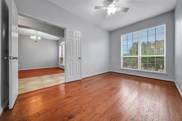 unfurnished room featuring light wood-type flooring, plenty of natural light, and baseboards