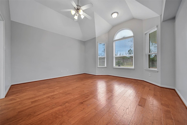 unfurnished room featuring a ceiling fan, lofted ceiling, baseboards, and wood finished floors