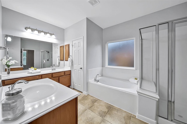 bathroom with double vanity, visible vents, a garden tub, a shower stall, and a sink