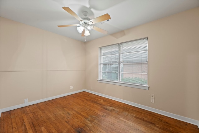 spare room featuring wood-type flooring and ceiling fan