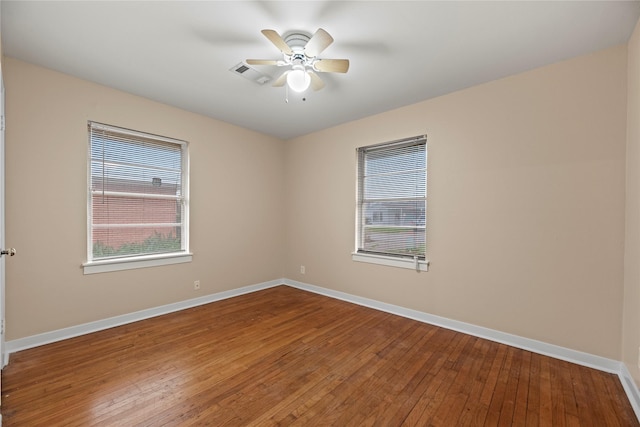 unfurnished room with hardwood / wood-style floors and ceiling fan